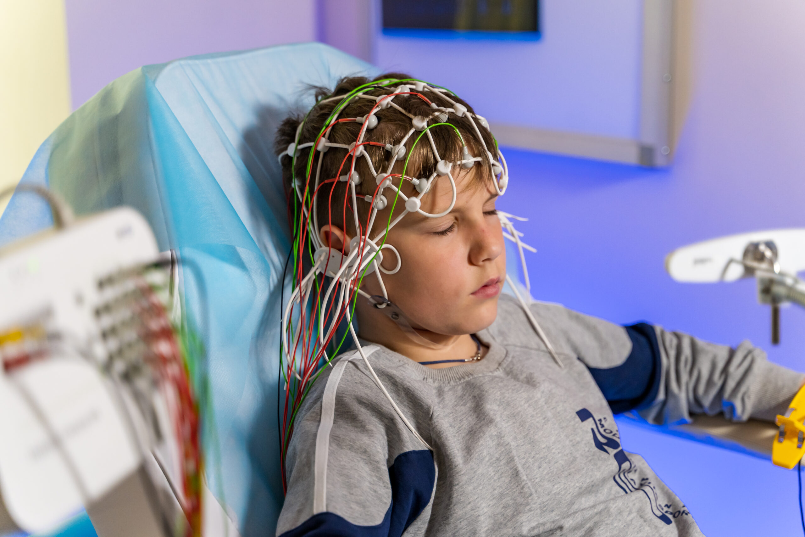 EEG electrode placement to patient during EEG record.