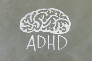 Illustration of a brain with the text 'ADHD', representing how neurofeedback for ADHD can help improve focus, attention, and cognitive function. | Mind Brain Institute
