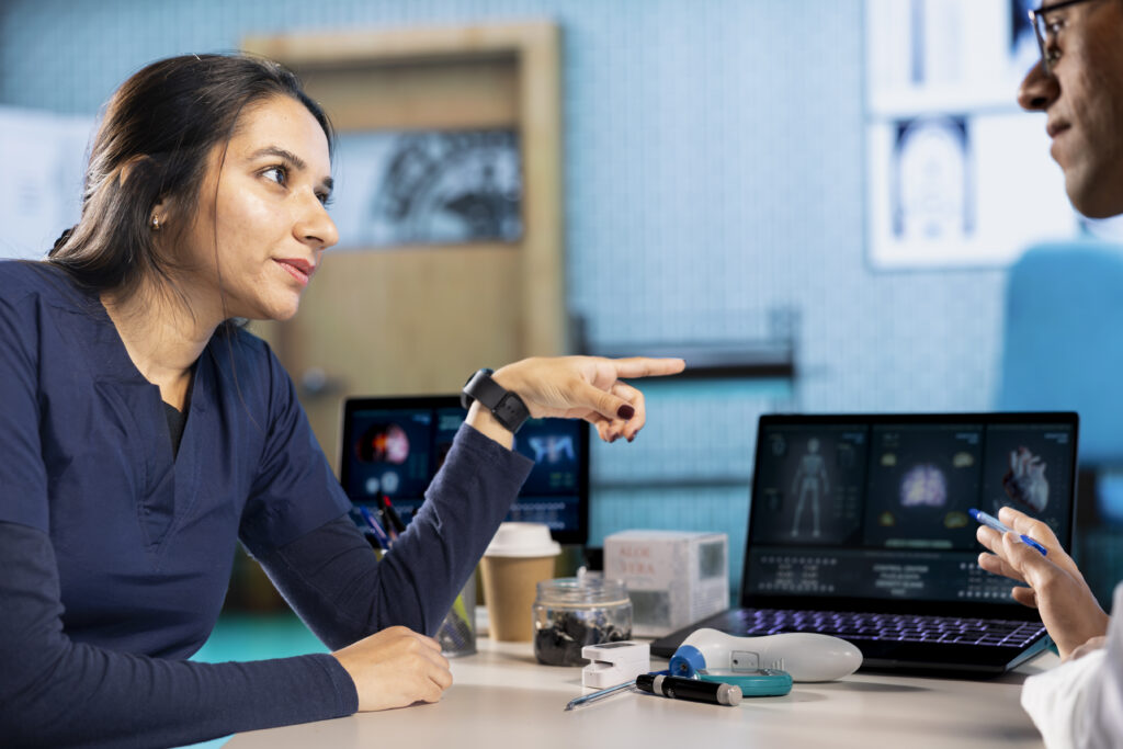 A woman can be seen talking to a doctor 