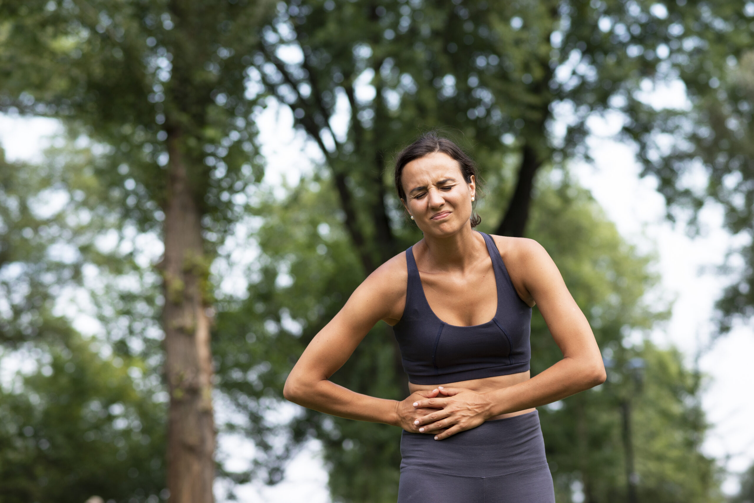 A woman can be seen experiencing a stomach pain